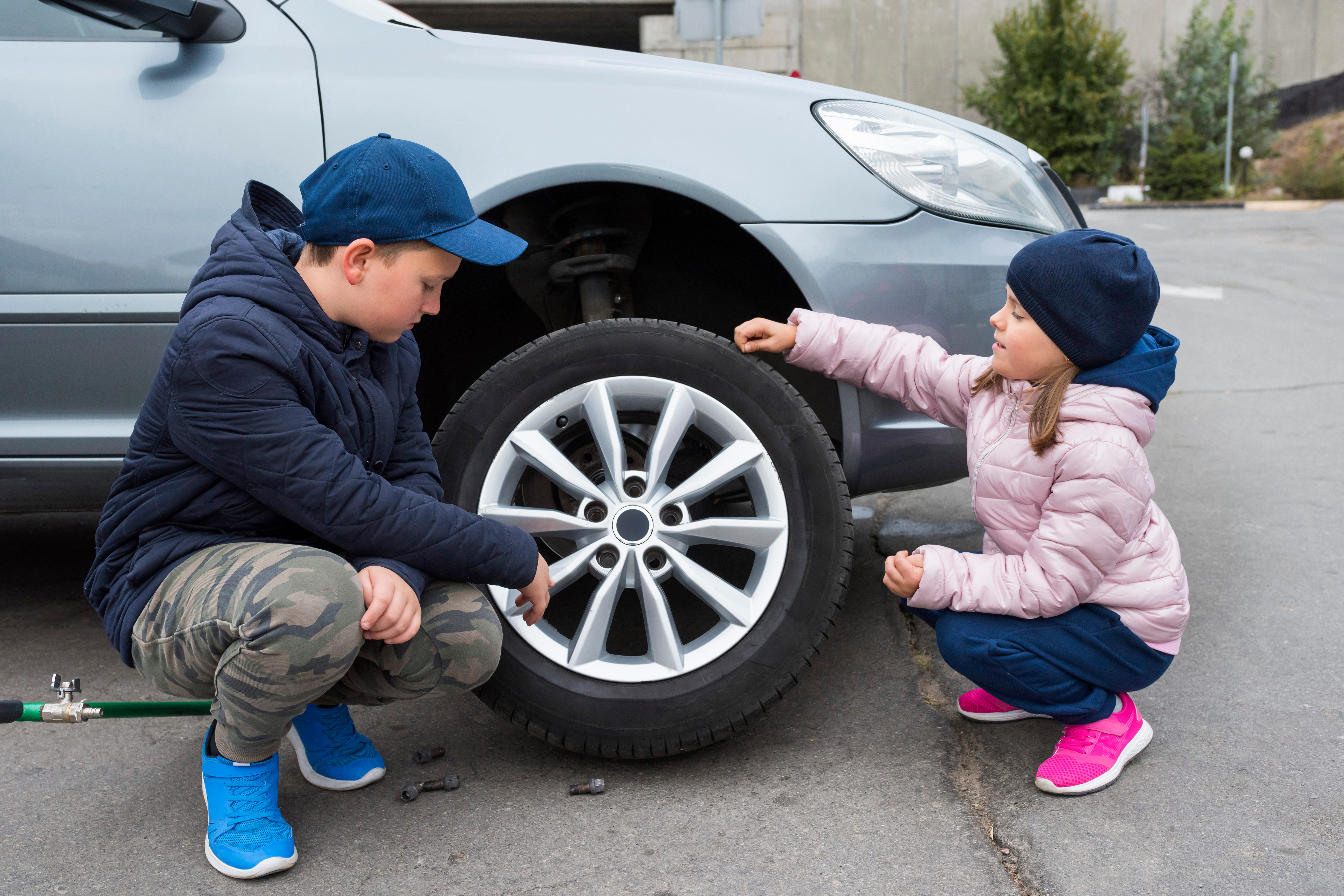 Young people changing a car tire